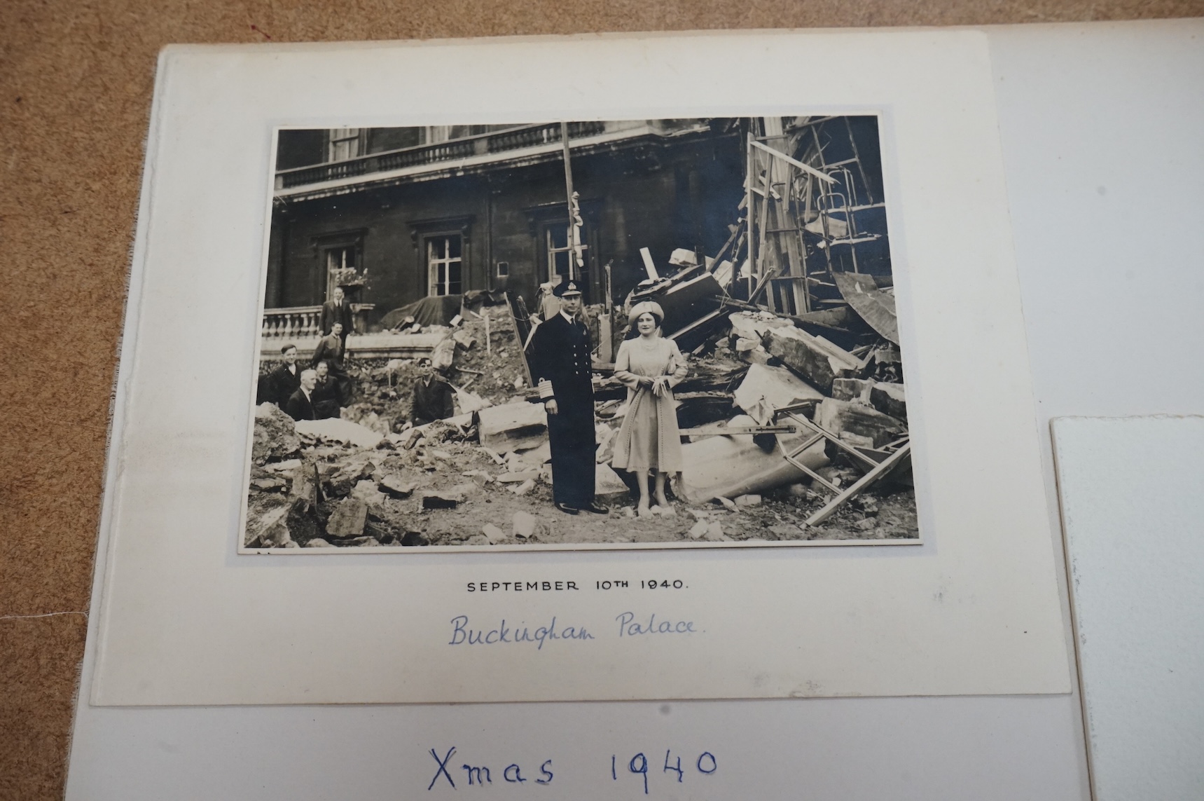 Two Royal Christmas cards; a card for Christmas 1940, the image used being a photograph of HM King George VI and Queen Elizabeth against a backdrop of the bomb damage at Buckingham Palace, dated ‘September 10th 1940’ (un